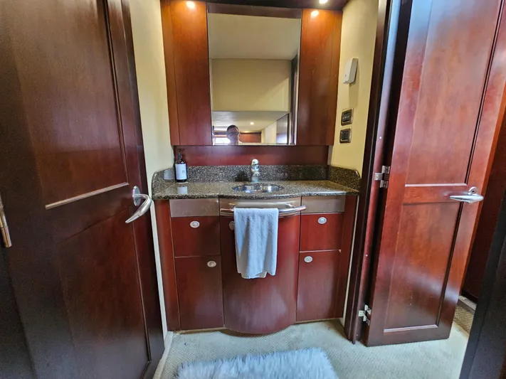 Wrist Shot Yacht Photos Pics Luxurious bathroom vanity in 2005 Sea Ray 48 Sundancer yacht with wood cabinetry and modern fixtures.