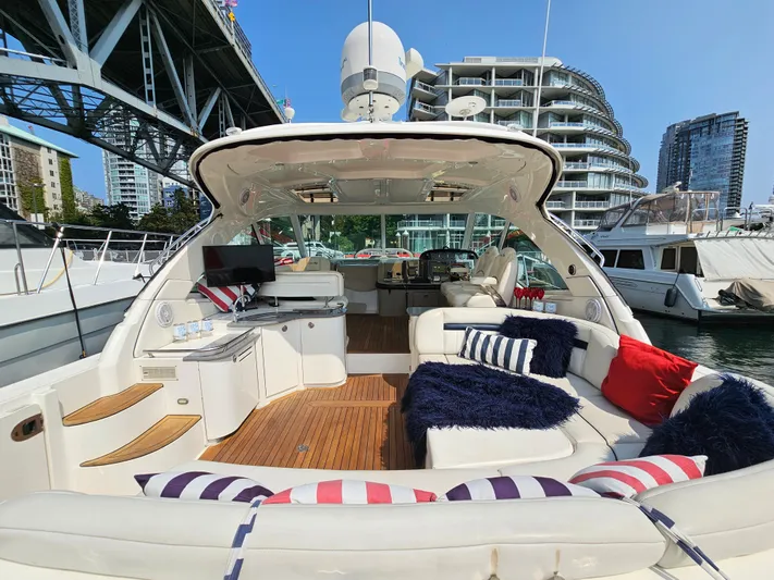 Wrist Shot Yacht Photos Pics 2005 Sea Ray 48 Sundancer yacht with luxurious seating and modern amenities, docked under a bridge.