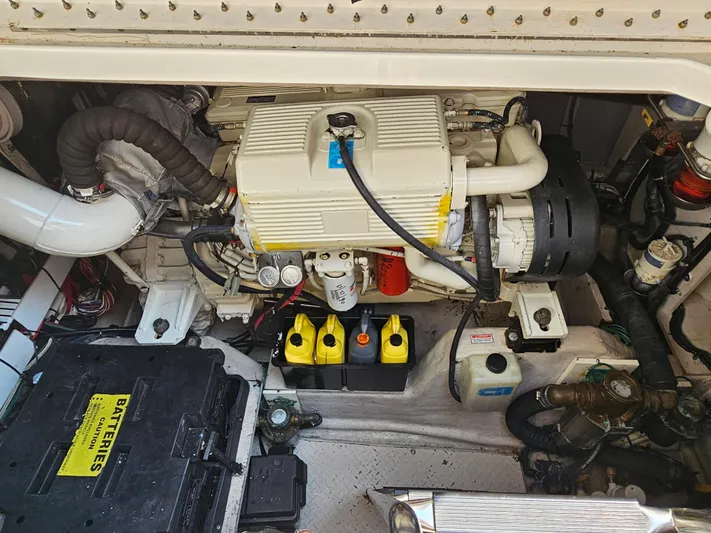 Wrist Shot Yacht Photos Pics Engine compartment of a 2005 Sea Ray 48 Sundancer, showcasing batteries and mechanical components.