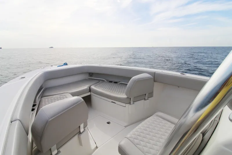  Yacht Photos Pics 2019 Jupiter 30 HFS boat interior with cushioned seating, overlooking calm ocean waters.