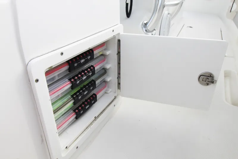  Yacht Photos Pics Open storage compartment on 2019 Jupiter 30 HFS boat, showcasing organized tackle boxes.