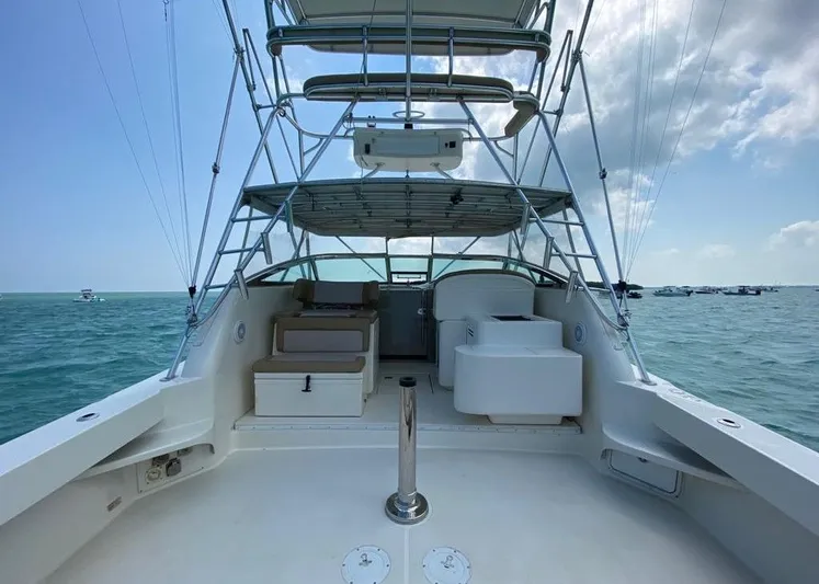 Vamonos Yacht Photos Pics 2001 Sea Ray 340 Amberjack boat on open water, featuring spacious deck and seating.