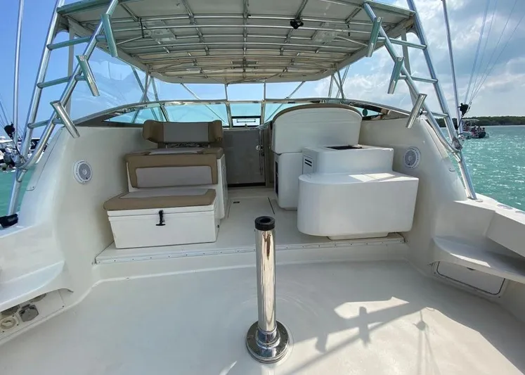 Vamonos Yacht Photos Pics 2001 Sea Ray 340 Amberjack boat interior with seating and helm, under a clear blue sky.