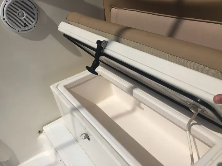 Vamonos Yacht Photos Pics Open storage compartment on 2001 Sea Ray 340 Amberjack boat, featuring a speaker and cushioned seat.