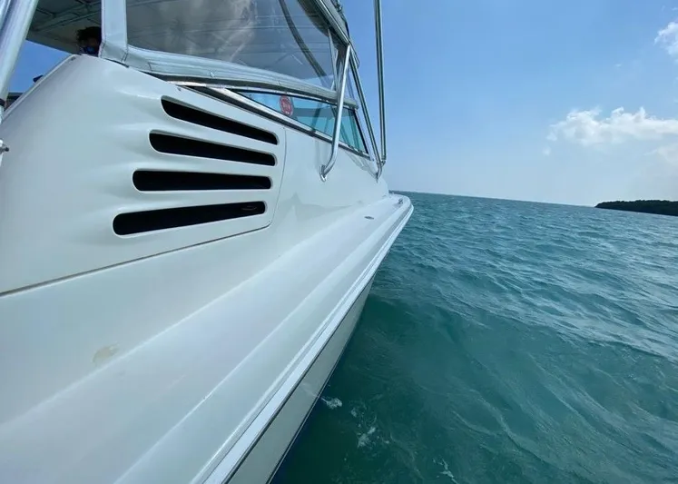 Vamonos Yacht Photos Pics 2001 Sea Ray 340 Amberjack cruising on open water under clear blue sky.