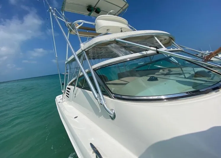 Vamonos Yacht Photos Pics 2001 Sea Ray 340 Amberjack boat cruising on clear blue water under a sunny sky.