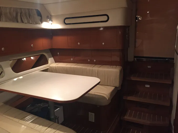 Vamonos Yacht Photos Pics Interior of 2001 Sea Ray 340 Amberjack with dining area and wooden cabinetry.