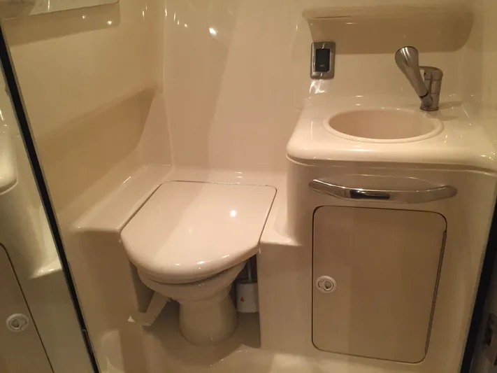 Vamonos Yacht Photos Pics 2001 Sea Ray 340 Amberjack bathroom with toilet and sink, compact marine design.