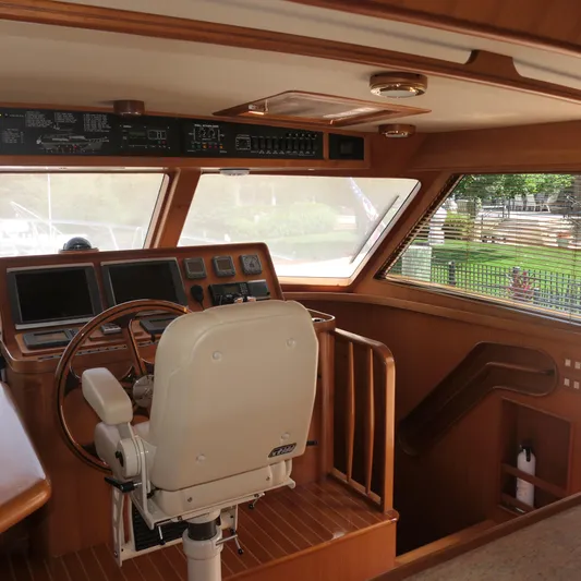  Yacht Photos Pics 2008 Marlow 53 C Explorer yacht helm with wooden interior and navigation equipment.