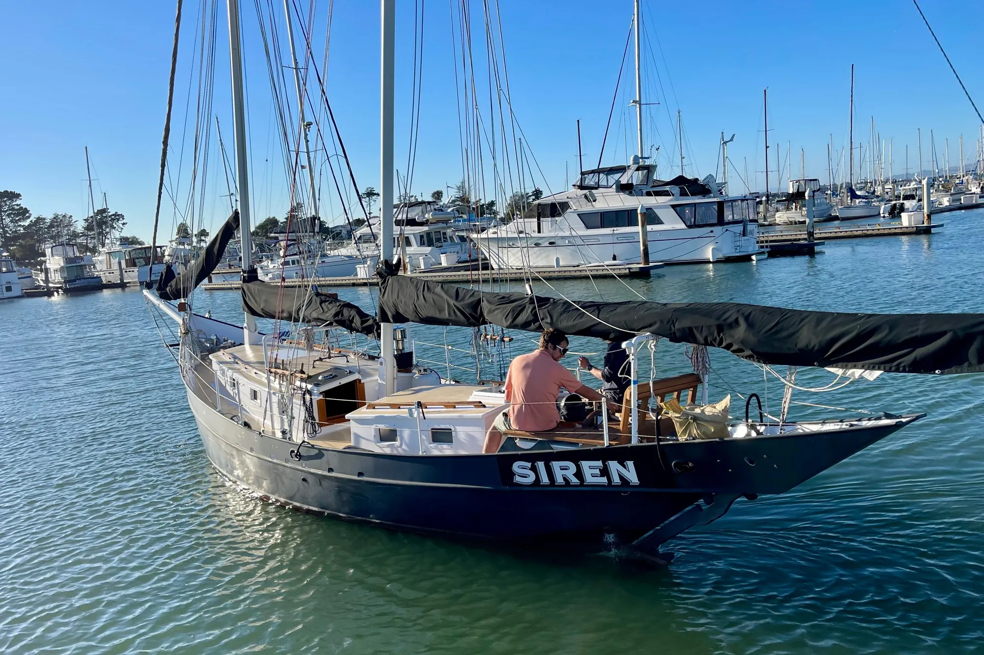 Sailboat "Siren" by Pinky, Custom model, 2008, docked in a marina under clear skies.