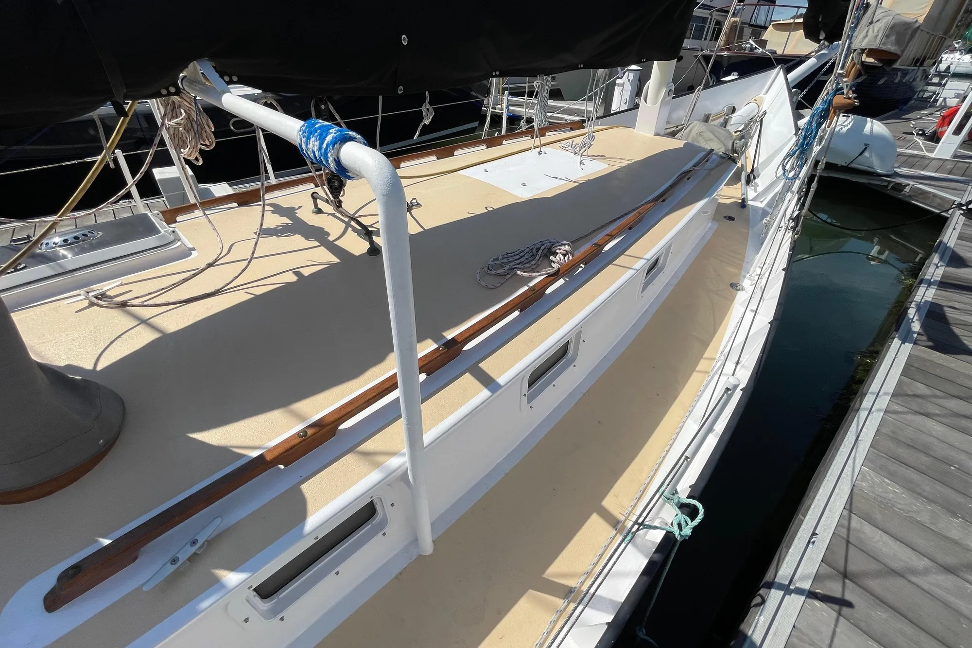Sailboat deck view, Pinky Custom 2008 model, docked at marina with ropes and equipment.
