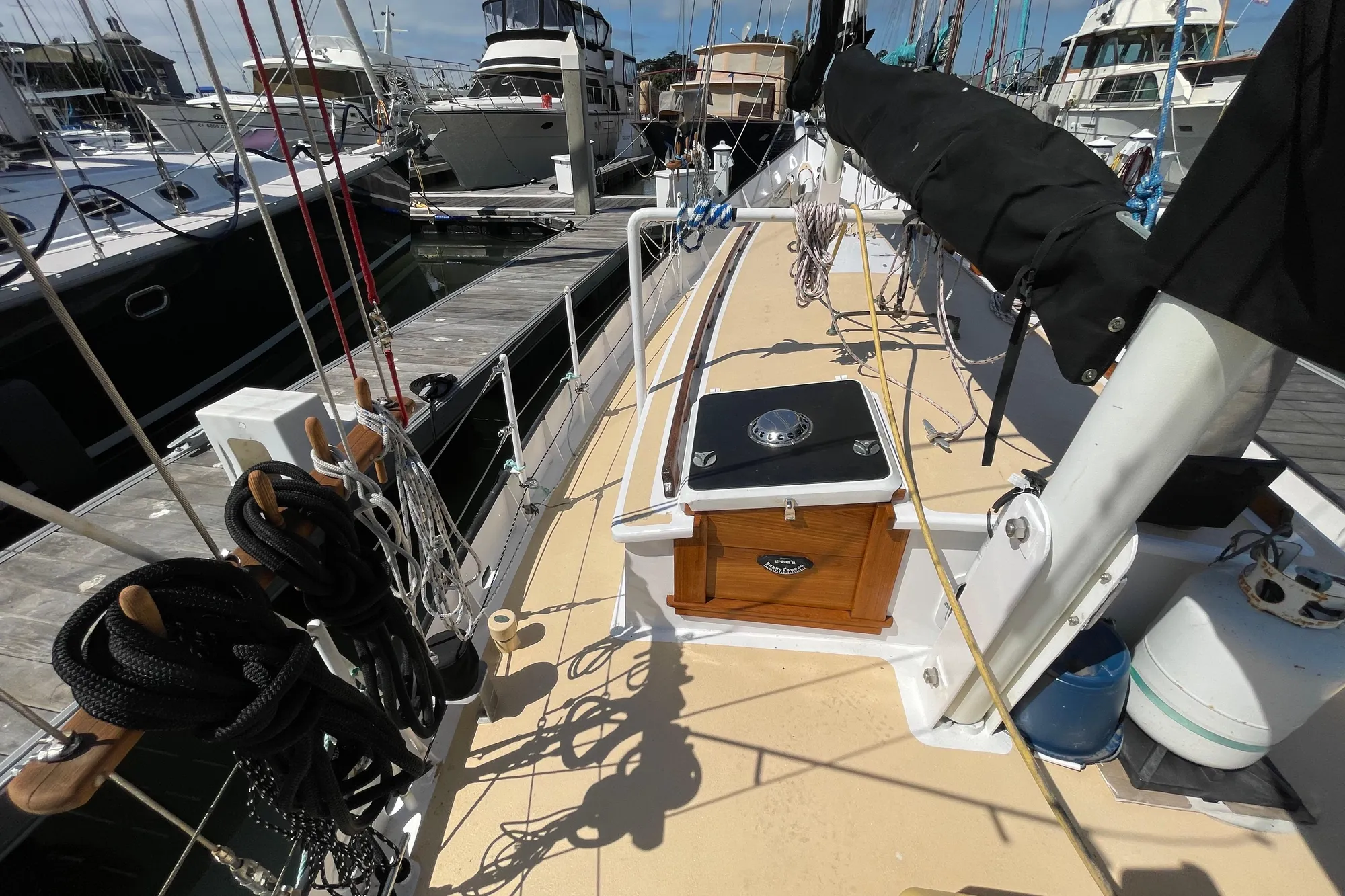 Sailboat deck view, Pinky Custom 2008, docked at marina with ropes and equipment.
