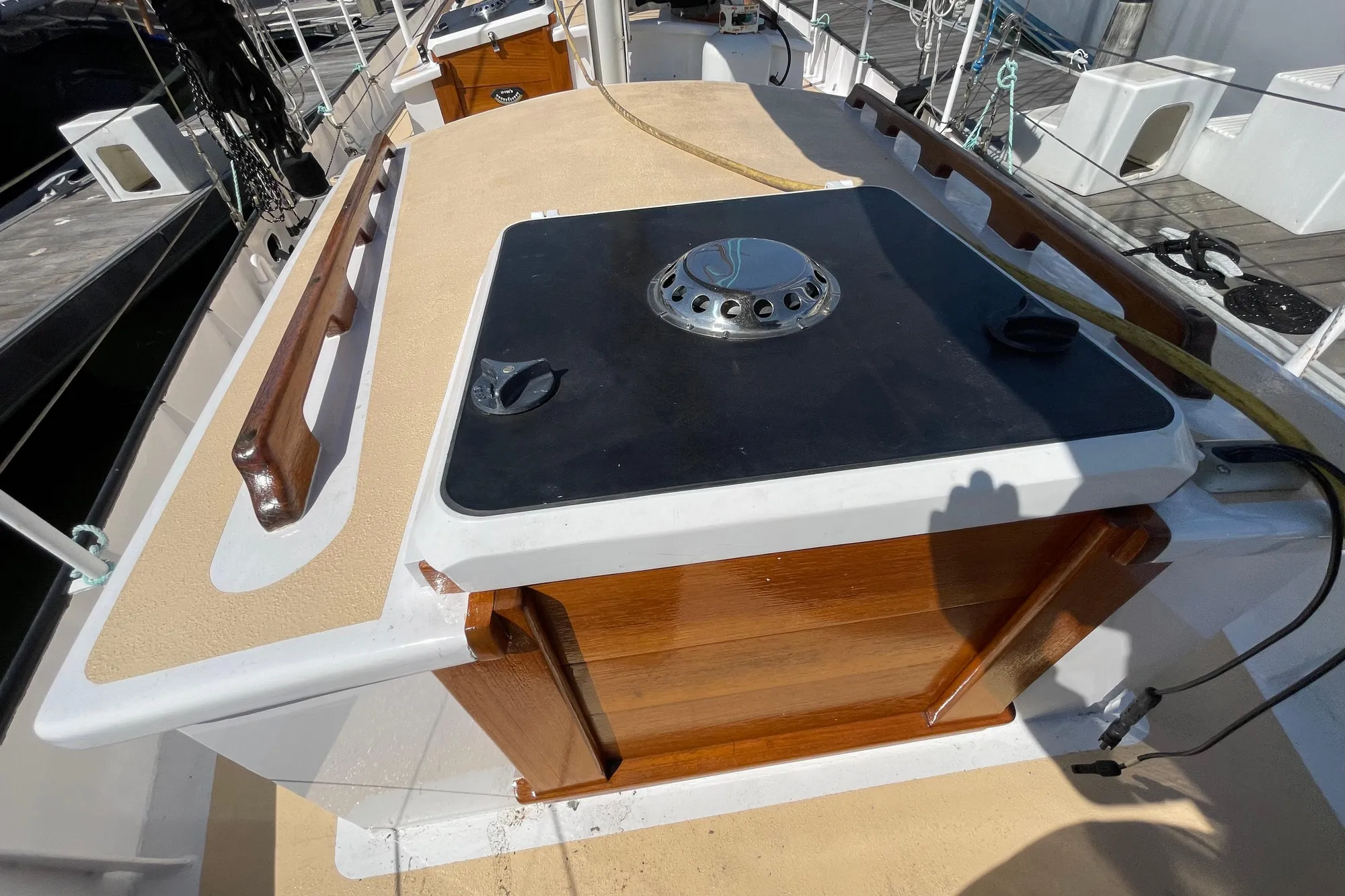 2008 Pinky Custom boat deck with wooden accents and a central hatch.