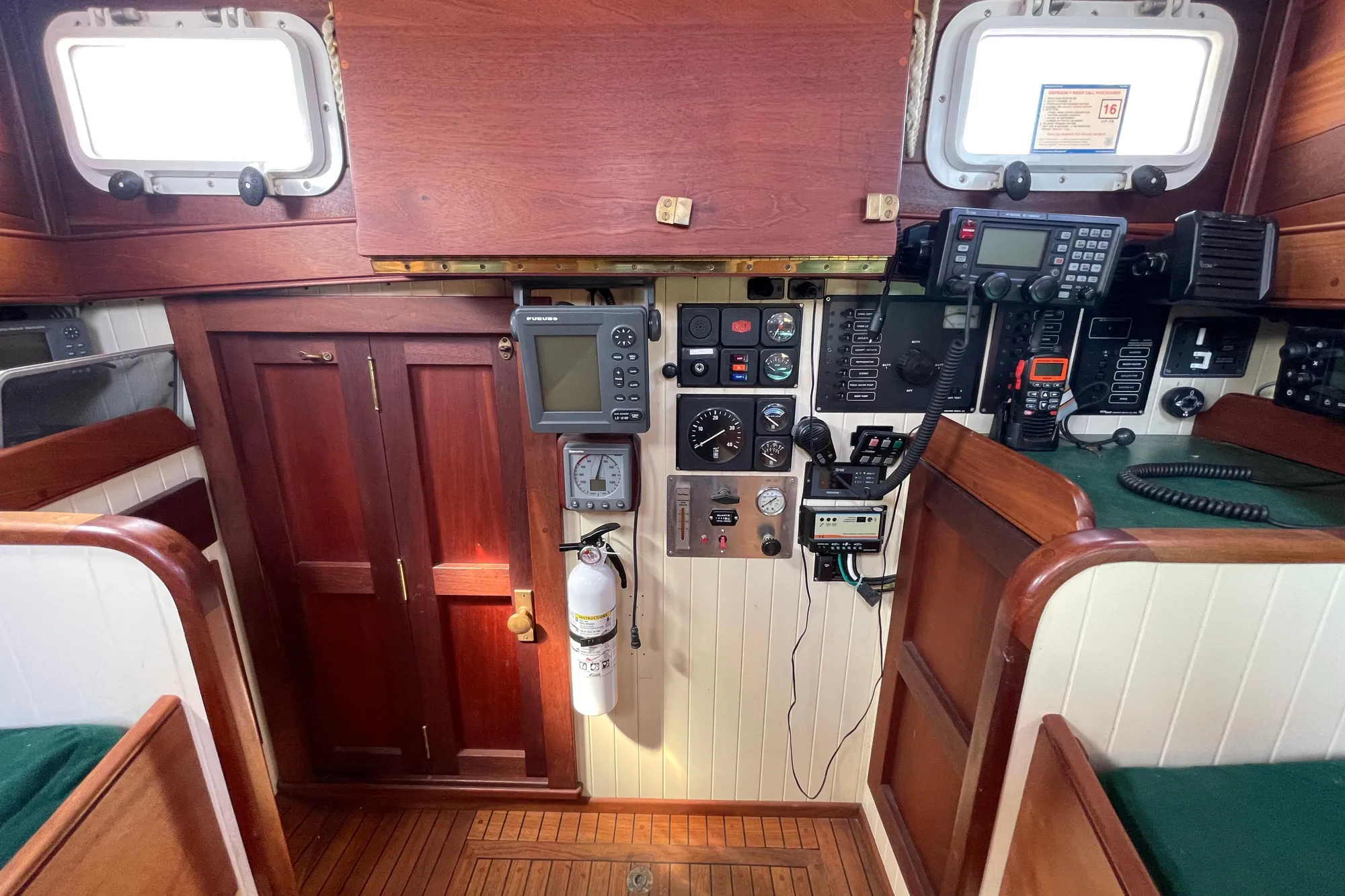 Interior of 2008 Pinky Custom boat with navigation equipment and wooden cabinetry.