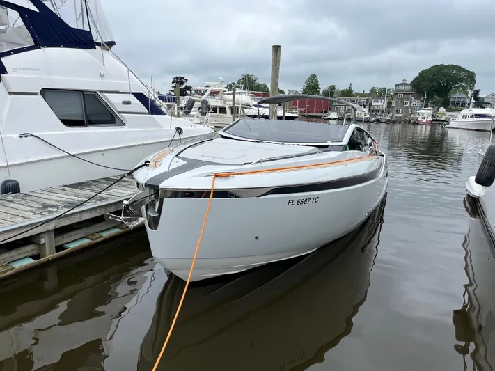  Yacht Photos Pics 2022 Fairline F//Line 33 yacht docked at marina, sleek design, overcast sky.