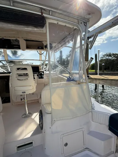  Yacht Photos Pics 2007 Grady-White Express 330 boat interior with helm and seating, docked by the water.