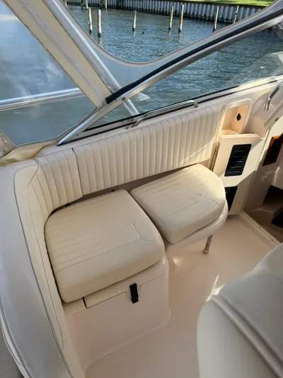  Yacht Photos Pics 2007 Grady-White Express 330 boat interior with cream seating by the water.