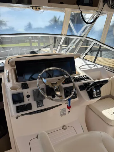  Yacht Photos Pics 2007 Grady-White Express 330 helm with steering wheel and control panel.