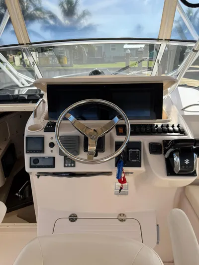  Yacht Photos Pics Helm of 2007 Grady-White Express 330 boat with steering wheel and navigation controls.