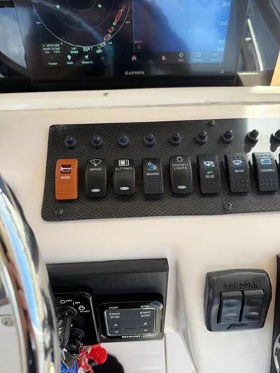  Yacht Photos Pics Control panel of a 2007 Grady-White Express 330 boat with various switches and a Garmin display.