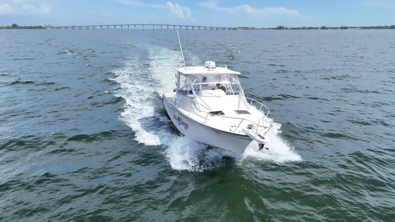  Yacht Photos Pics 2007 Grady-White Express 330 cruising on open water with bridge in background.