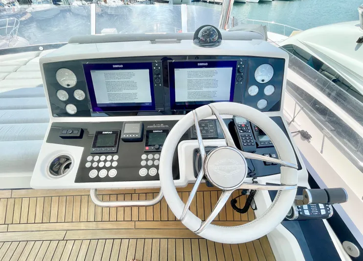 Excellence Yacht Photos Pics Control panel of 2019 Sunseeker Manhattan 66 yacht with dual screens and steering wheel.