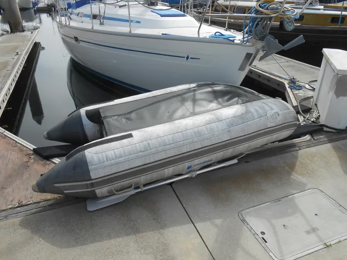 Pilitak Yacht Photos Pics Inflatable boat docked beside a 2001 Bavaria 37 yacht in a marina.