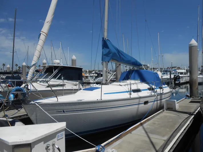 Pilitak Yacht Photos Pics 2001 Bavaria 37 sailboat docked at marina under clear blue sky.
