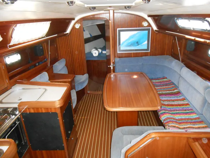 Pilitak Yacht Photos Pics Interior of 2001 Bavaria 37 yacht with wooden finish and cozy seating area.