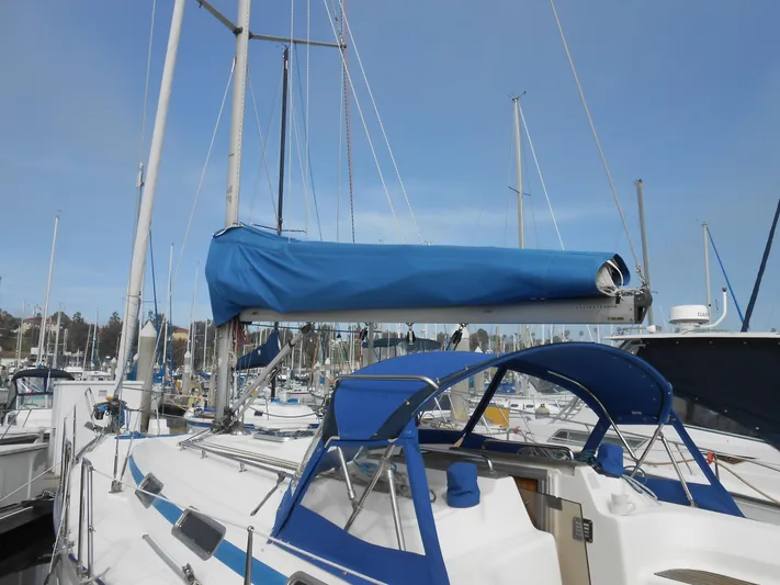 Pilitak Yacht Photos Pics 2001 Bavaria 37 sailboat with blue covers docked in a marina.