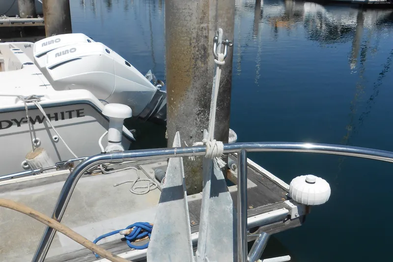 Pilitak Yacht Photos Pics Bavaria 37 yacht anchored at marina, 2001 model, with visible boat equipment and water reflection.