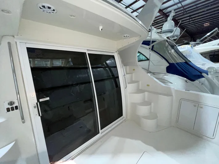  Yacht Photos Pics 2005 Carver 42 Mariner yacht interior with sliding glass door and staircase.