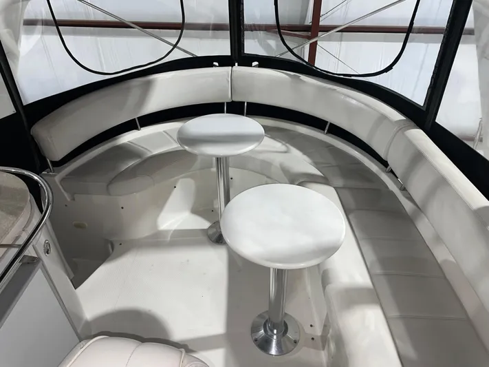  Yacht Photos Pics Interior of 2005 Carver 42 Mariner yacht with white seating and tables.