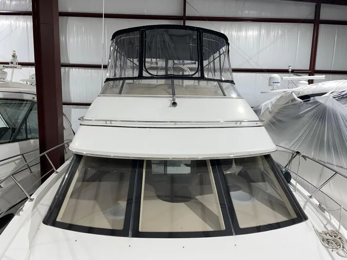  Yacht Photos Pics 2005 Carver 42 Mariner yacht in storage, featuring a sleek design and spacious flybridge.