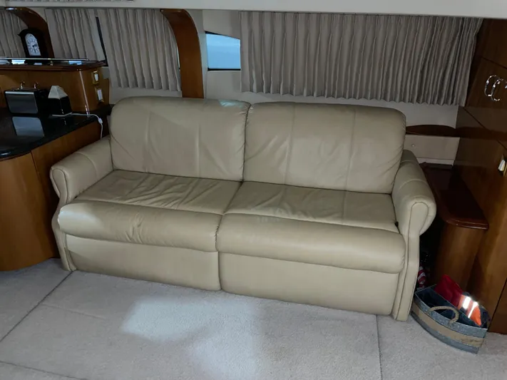  Yacht Photos Pics Beige leather sofa in 2005 Carver 42 Mariner yacht interior, with wood accents and curtains.