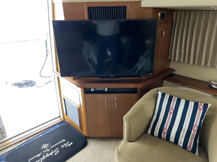  Yacht Photos Pics Interior of 2005 Carver 42 Mariner with TV, armchair, and nautical-themed pillow.