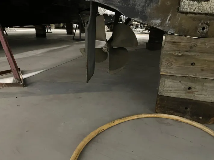  Yacht Photos Pics Propeller of a 2005 Carver 42 Mariner yacht in dry dock, with wooden supports.