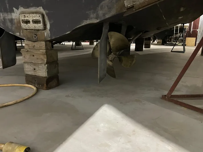  Yacht Photos Pics 2005 Carver 42 Mariner boat propeller and hull supported by wooden blocks in a workshop.