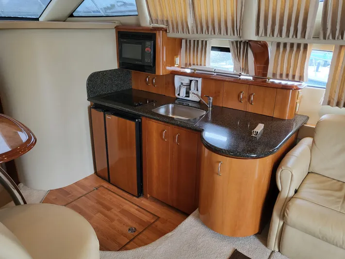  Yacht Photos Pics Interior of 2005 Carver 42 Mariner yacht with kitchenette and seating area.