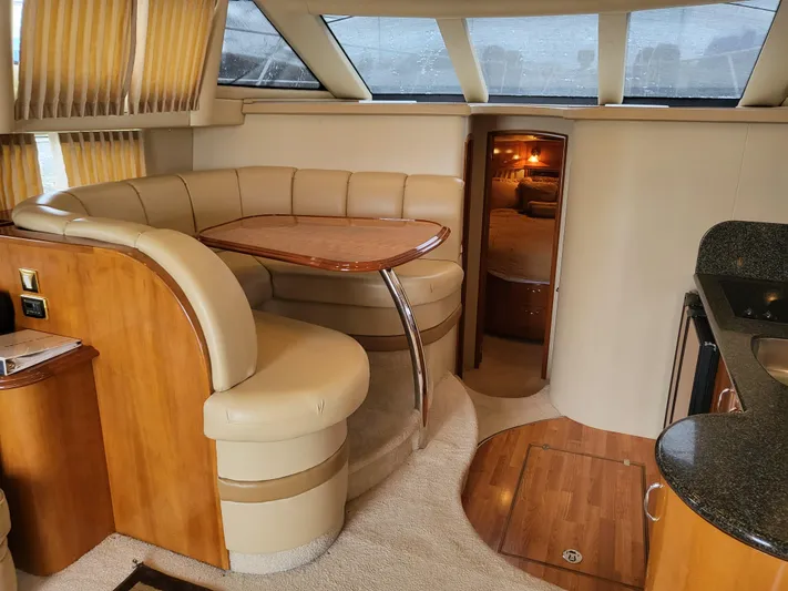  Yacht Photos Pics Interior of 2005 Carver 42 Mariner yacht with dining area and modern furnishings.