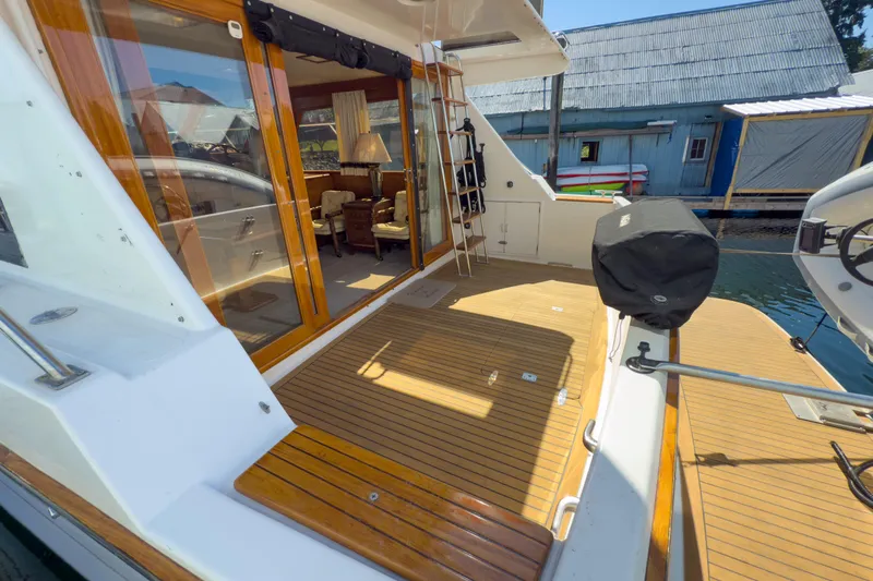 Silver Spring Yacht Photos Pics 1985 Ocean Alexander 420 Sport Sedan yacht with wooden deck and glass doors.