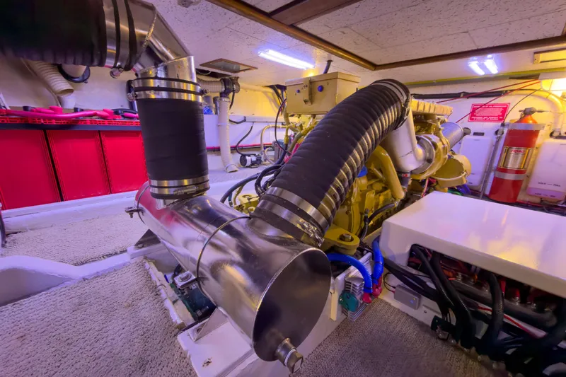 Silver Spring Yacht Photos Pics Engine room of 1985 Ocean Alexander 420 Sport Sedan with visible exhaust system and fire extinguisher.