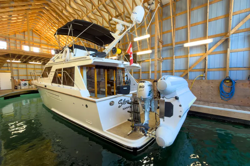 Silver Spring Yacht Photos Pics 1985 Ocean Alexander 420 Sport Sedan docked in a wooden boathouse.