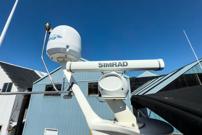 Silver Spring Yacht Photos Pics Radar and satellite equipment on 1985 Ocean Alexander 420 Sport Sedan against blue sky.