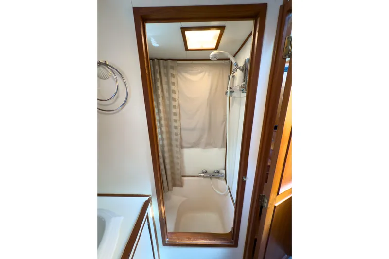 Silver Spring Yacht Photos Pics Bathroom interior of 1985 Ocean Alexander 420 Sport Sedan yacht with shower and curtain.