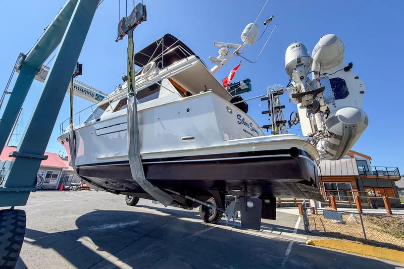 Silver Spring Yacht Photos Pics 1985 Ocean Alexander 420 Sport Sedan yacht being lifted at a marina.