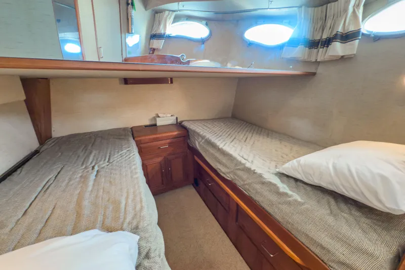 Silver Spring Yacht Photos Pics 1985 Ocean Alexander 420 Sport Sedan cabin with twin beds and wooden cabinetry.