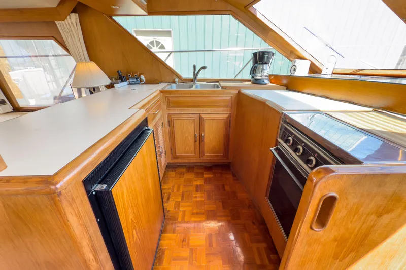 Silver Spring Yacht Photos Pics 1985 Ocean Alexander 420 Sport Sedan kitchen with wood cabinetry and modern appliances.