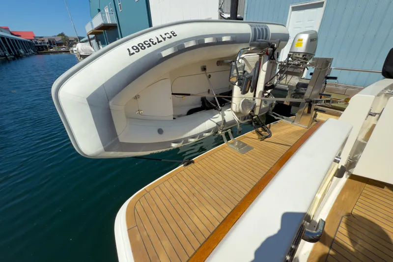 Silver Spring Yacht Photos Pics 1985 Ocean Alexander 420 Sport Sedan with dinghy on teak deck, docked at marina.