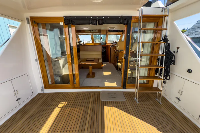 Silver Spring Yacht Photos Pics 1985 Ocean Alexander 420 Sport Sedan yacht interior with wooden accents and ladder.